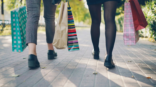 Two people walking with shopping bags