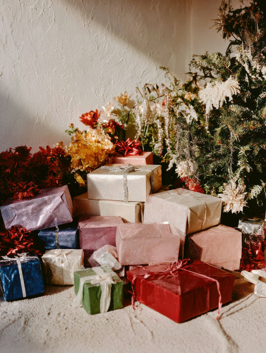 Pile of wrapped gifts near a decorated christmas tree