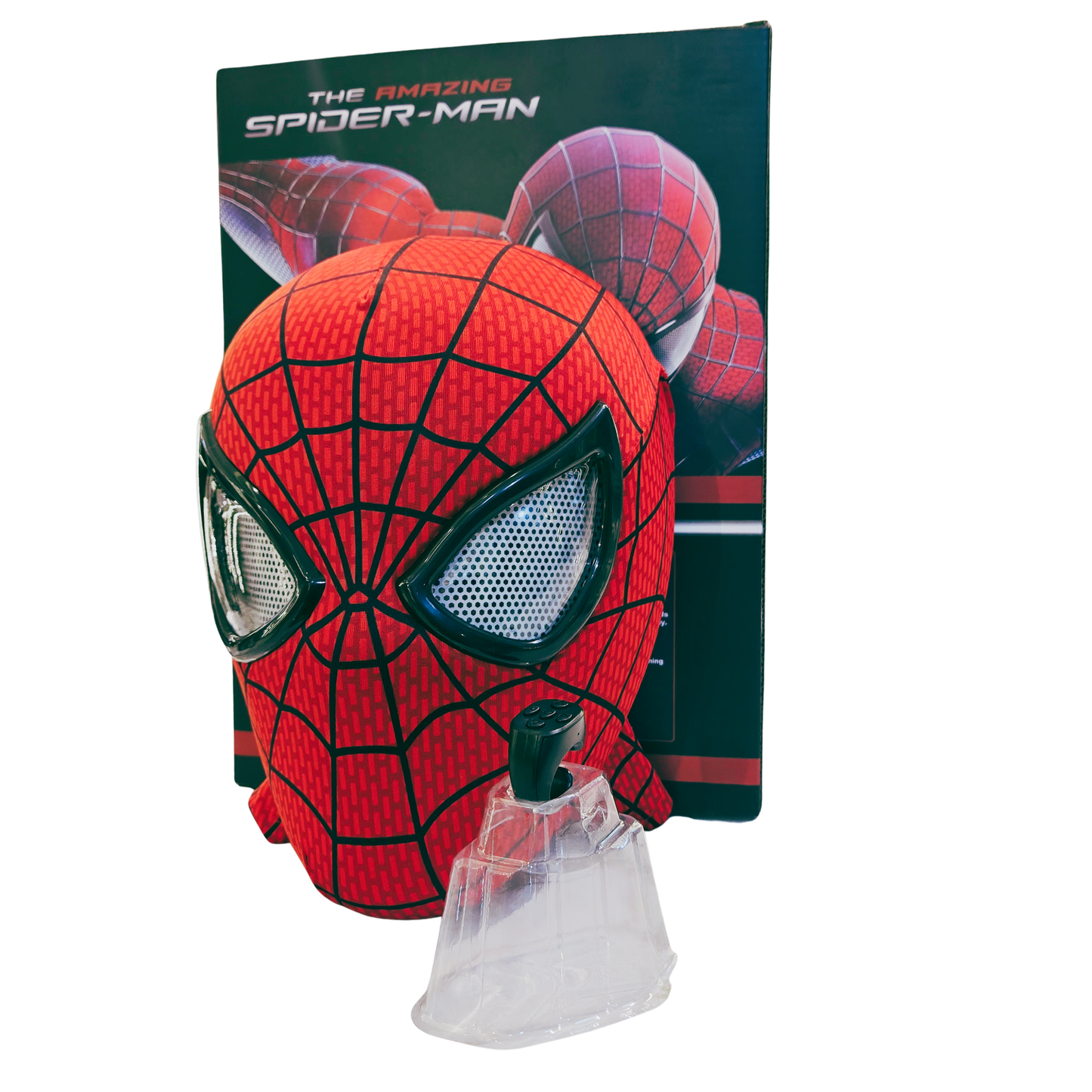 A red and black Spider-Man mask with a clear plastic face shield, displayed in front of its dark green 'The Amazing Spider-Man' branded backing card on a white background.